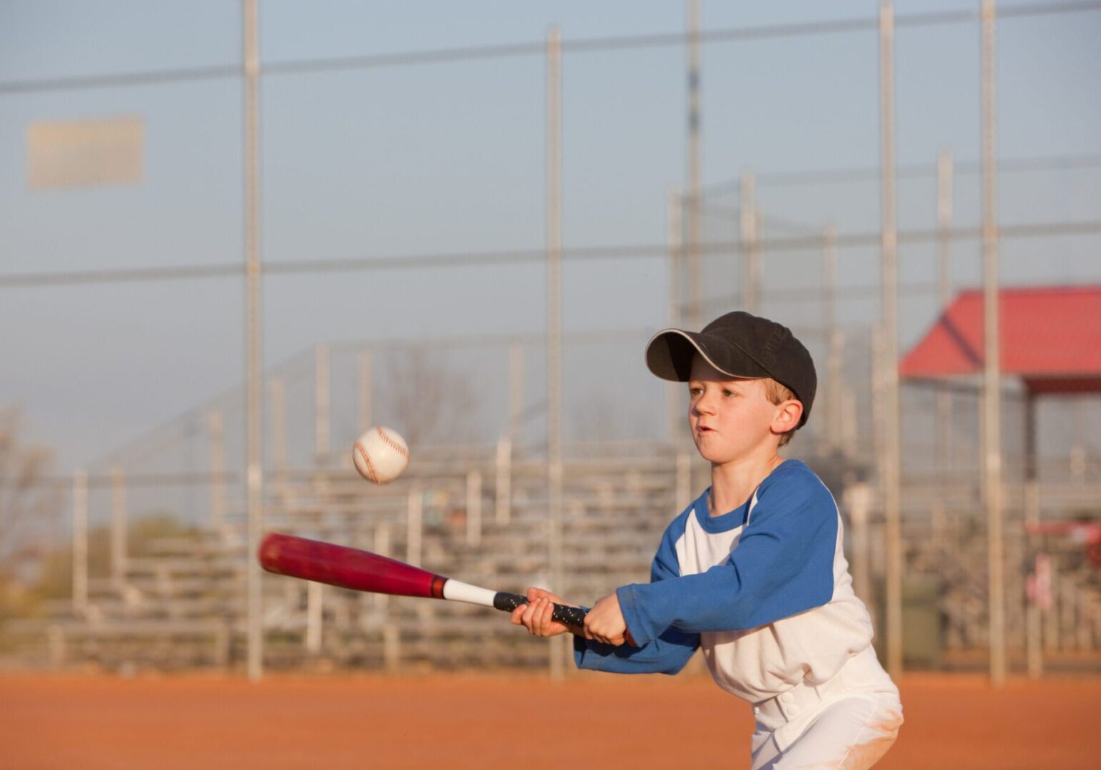 Young boy playing baseball, ready to bat.