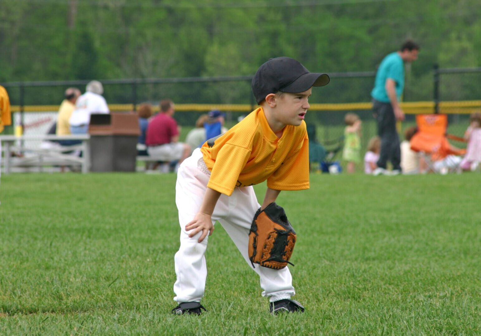 Young boy playing baseball on field.